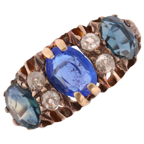 1312 - An 18ct gold seven stone sapphire and diamond half hoop ring, centrally set with oval mixed-cut coru... 