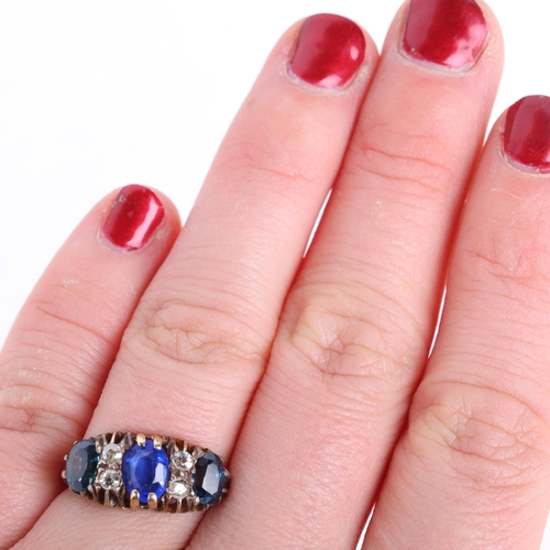 1312 - An 18ct gold seven stone sapphire and diamond half hoop ring, centrally set with oval mixed-cut coru... 