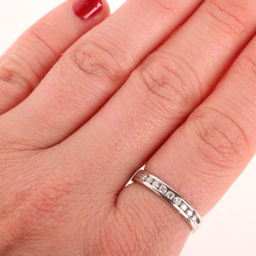 1313 - An 18th white gold diamond half eternity ring, channel set with modern round brilliant-cut diamonds,... 