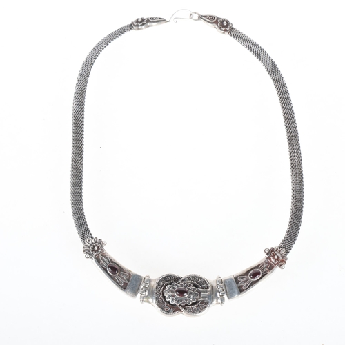 1364 - A Mexican sterling silver garnet collar necklace, relief embossed decoration, maker H64, 44cm, 55.7g