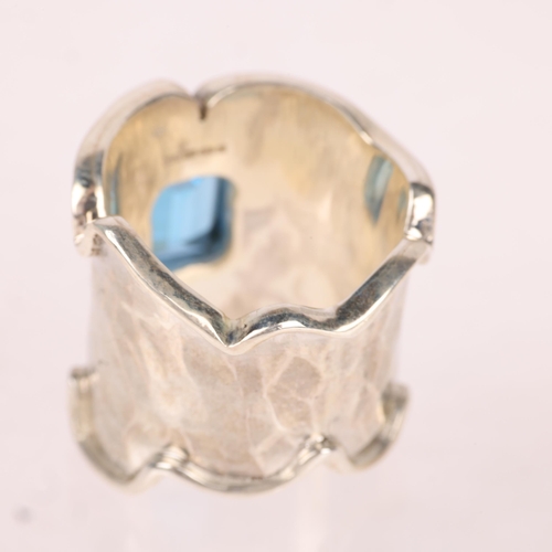 1388 - A sterling silver blue topaz band ring, setting height 21.7mm, size N, 14.4g