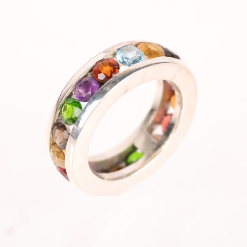 1390 - A heavy sterling silver gem set eternity ring, gemstones include amethyst citrine smoky quartz etc, ... 