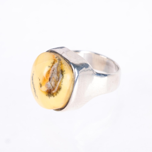 1433 - FRANTS HOGDAHL KRISTENSEN - a Danish modernist sterling silver Baltic amber abstract ring, setting h... 