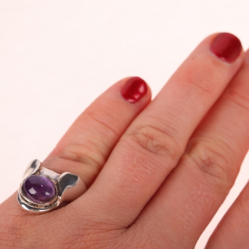 1449 - PETER ERNST RAVBUTIKKEN - a Danish modernist sterling silver amethyst ring, set with oval cabochon a... 