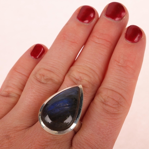 1453 - A sterling silver labradorite dress ring, set with pear cabochon labradorite, setting height 28.8mm,... 