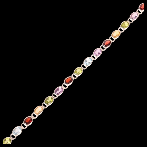 1454 - A sterling silver gem set tennis line bracelet, gemstones include garnet amethyst peridot and citrin... 