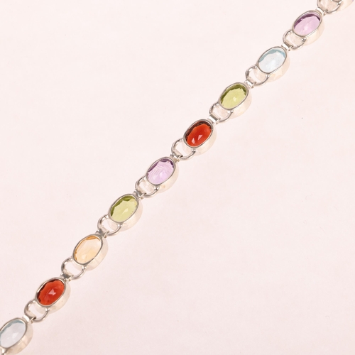 1454 - A sterling silver gem set tennis line bracelet, gemstones include garnet amethyst peridot and citrin... 