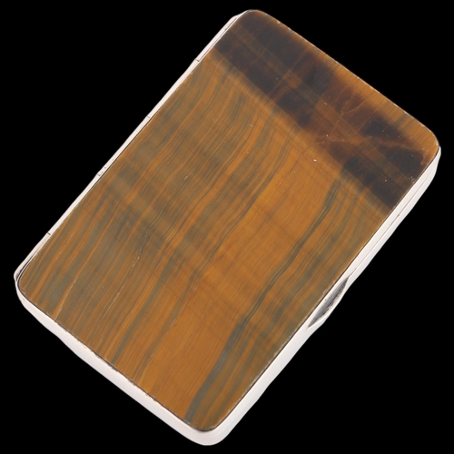 1501 - A sterling silver tigers eye cigarette case, each side set with polished rectangular tigers eye pane... 