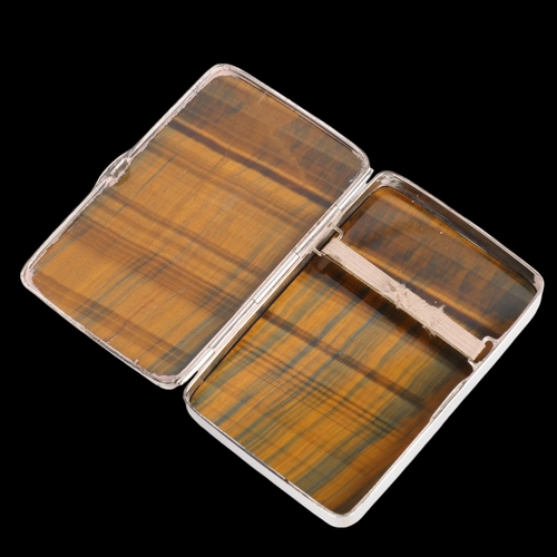 1501 - A sterling silver tigers eye cigarette case, each side set with polished rectangular tigers eye pane... 