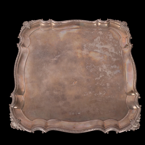 1574 - A George VI square silver salver, possibly Duncan & Scobbie, Birmingham 1937, shaped border with she... 