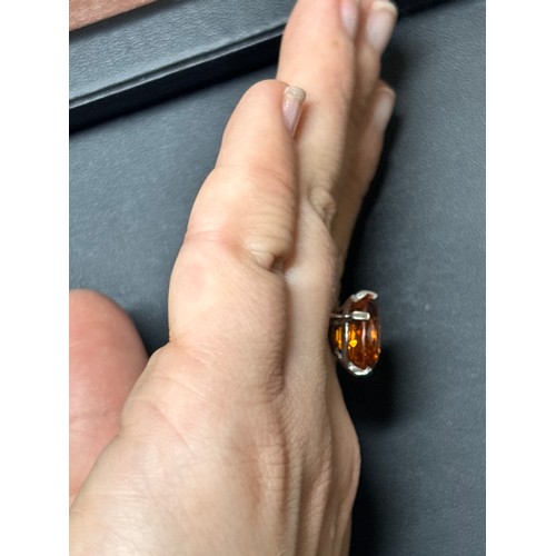 1171 - A platinum single stone citrine dress ring, set with oval mixed-cut citrine, setting height 16mm, si... 