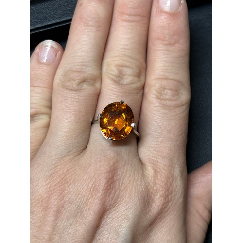 1171 - A platinum single stone citrine dress ring, set with oval mixed-cut citrine, setting height 16mm, si... 