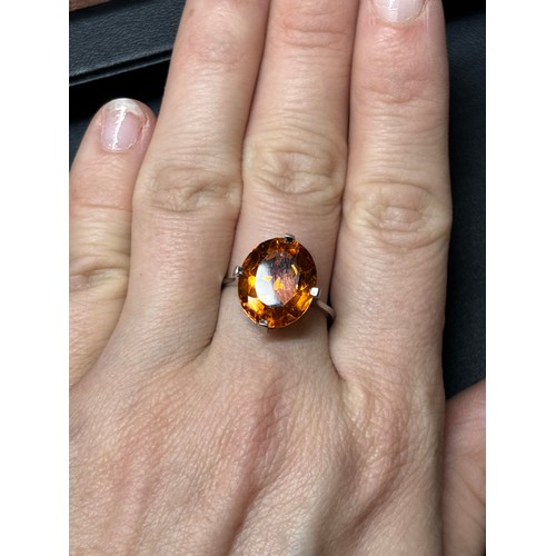 1171 - A platinum single stone citrine dress ring, set with oval mixed-cut citrine, setting height 16mm, si... 