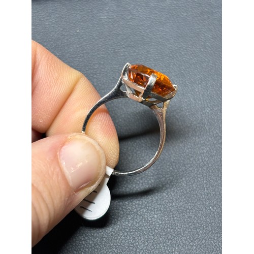 1171 - A platinum single stone citrine dress ring, set with oval mixed-cut citrine, setting height 16mm, si... 