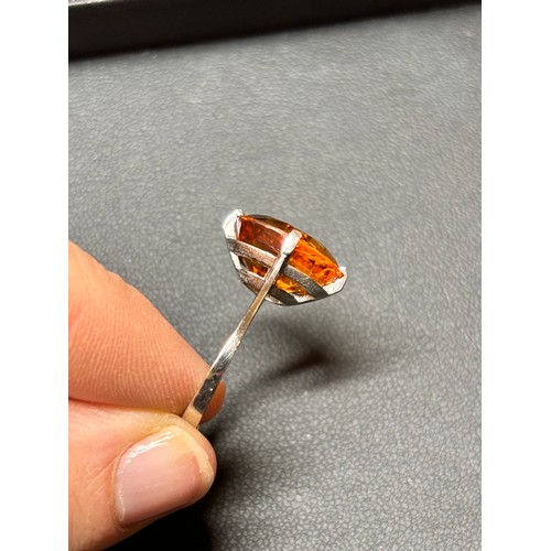 1171 - A platinum single stone citrine dress ring, set with oval mixed-cut citrine, setting height 16mm, si... 