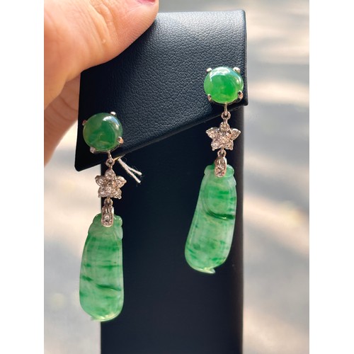 1145 - A pair of 18ct white gold jade and diamond drop stud earrings, each set with round cabochon jade sus... 