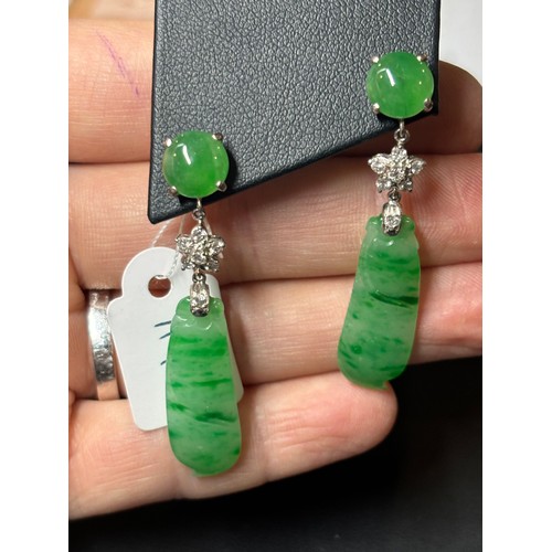 1145 - A pair of 18ct white gold jade and diamond drop stud earrings, each set with round cabochon jade sus... 