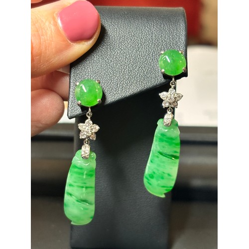 1145 - A pair of 18ct white gold jade and diamond drop stud earrings, each set with round cabochon jade sus... 