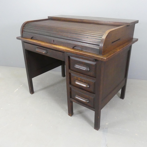 2547 - A 1930s oak roll-top bureau, with tambour front and four drawers.  W110cm, H94cm, D71cm.