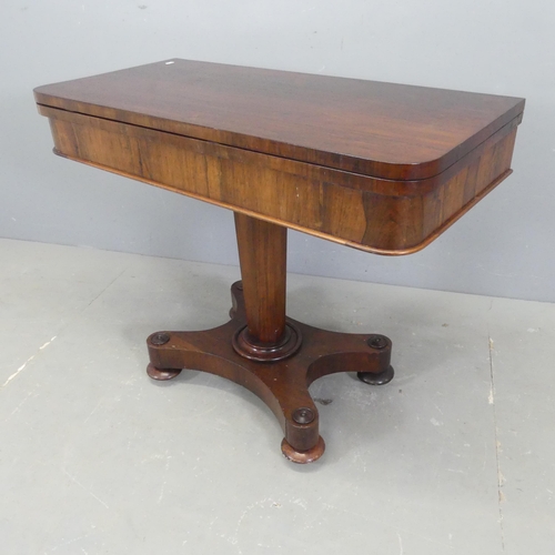 2566 - A 19th century rosewood fold-over card table, raised on tapered octagonal column with platform base.... 