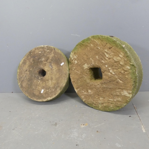 2623 - Two weathered sandstone mill-stone design ornaments. Largest D46cm.