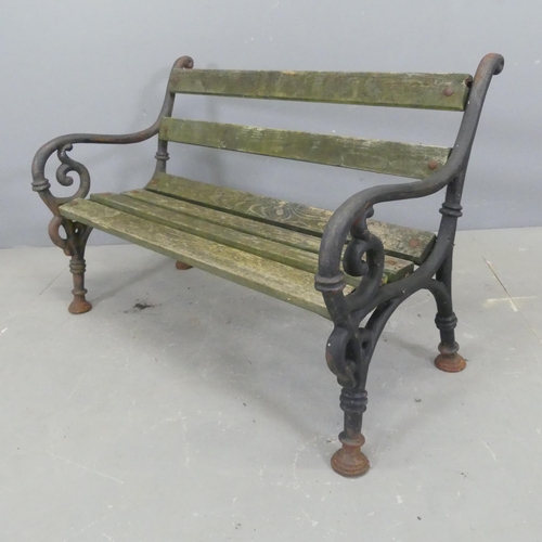 2633 - An antique teak slatted child's garden bench with painted cast iron ends. W86cm, H58cm, D47cm.