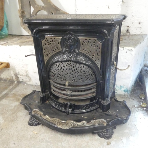 2638 - A painted cast iron log burning stove. W95cm, H80cm, D50cm.