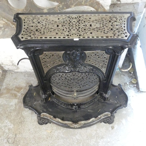 2638 - A painted cast iron log burning stove. W95cm, H80cm, D50cm.