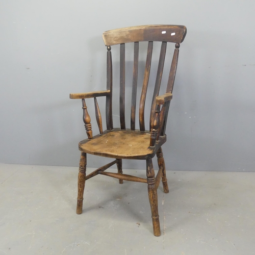 2709 - An antique elm-seated Windsor kitchen arm chair.