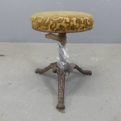 2720 - An antique upholstered footstool on cast iron frame, with rise and fall mechanism. A/F.