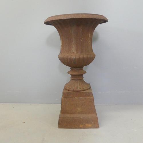 2724 - A cast-iron two-section Campana style urn on stand. D30cm, H50cm.