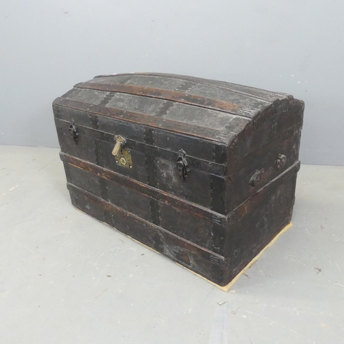 2727 - A Victorian leather covered and metal bound pine dome-top trunk. W88cm, H60cm, D49cm.