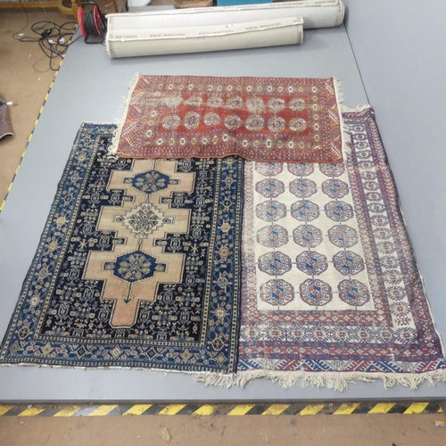 2301 - A blue ground Persian rug, 180x120cm, a cream ground Afghan rug, 190x120cm and another Afghan rug, 1... 