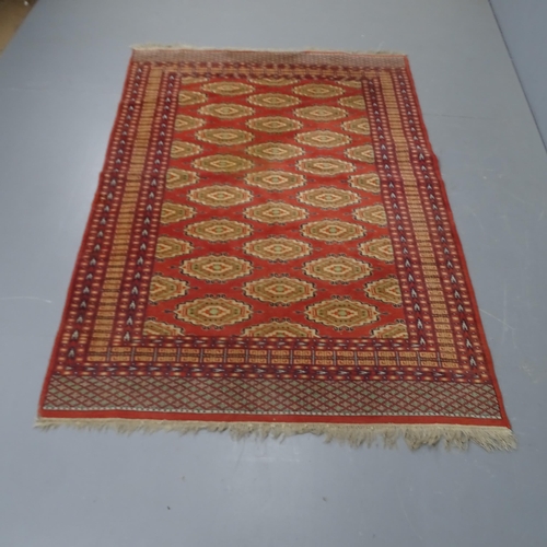 2300 - A Coral ground Tekke style rug,186 x 131cm