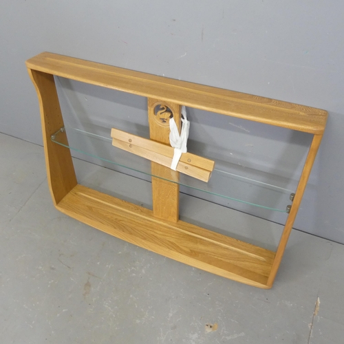 2504 - ERCOL - A light elm hanging shelf with swan design. Overall width 92cm, height 62cm, depth 18cm.... 