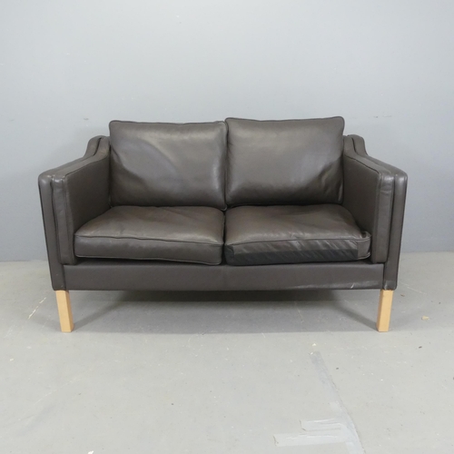 2515 - A modern Danish style leather upholstered two-seater sofa. Overall length 142cm, height 84cm, depth ... 