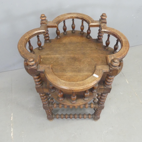 2516 - An antique oak plant stand with bobbin turned supports and galleried top. Width 66cm, height 81cm.