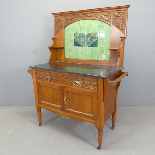 2518 - A Victorian Arts & Crafts style walnut and marble topped wash stand, with raised tiled back, carved ... 