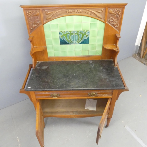 2518 - A Victorian Arts & Crafts style walnut and marble topped wash stand, with raised tiled back, carved ... 