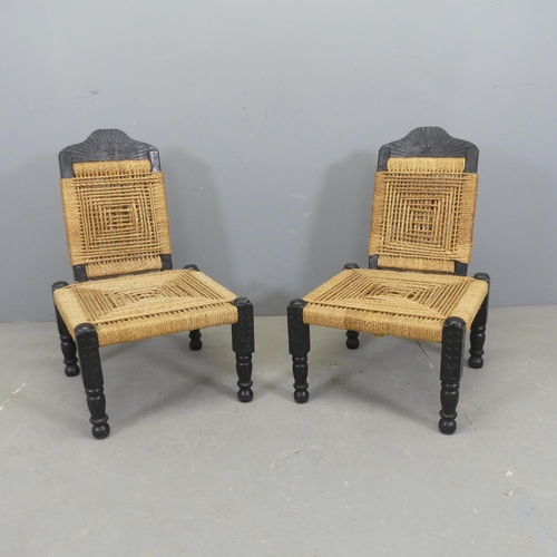 2531 - A pair of Indian painted mahogany low chairs, with jute panels, folding backs and carved decoration.