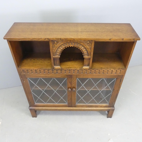 2543 - An early 20th century oak bookcase, with two lattice glazed doors and carved decoration. Width 101cm... 