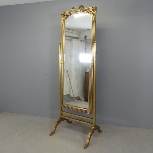 2545 - An ornate giltwood cheval mirror, with applied carved and fluted decoration. Width 64cm, height 187c... 