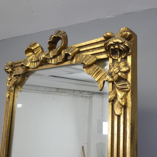 2545 - An ornate giltwood cheval mirror, with applied carved and fluted decoration. Width 64cm, height 187c... 