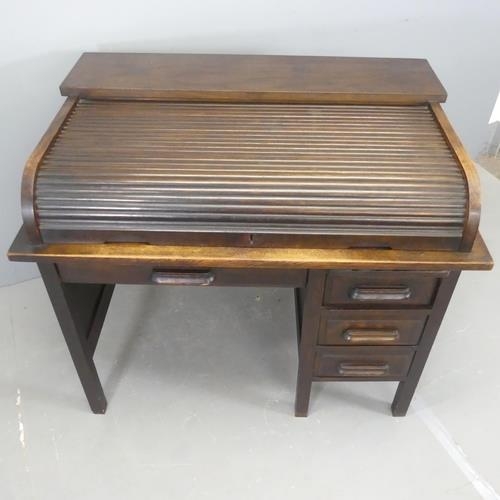 2547 - A 1930s oak roll-top bureau, with tambour front and four drawers.  W110cm, H94cm, D71cm.