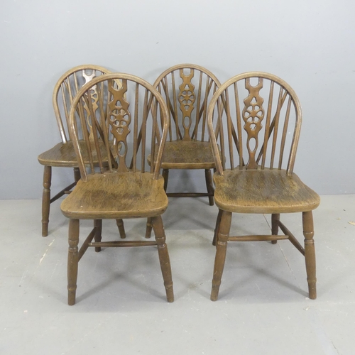 2552 - A set of four oak wheel-back dining chairs.