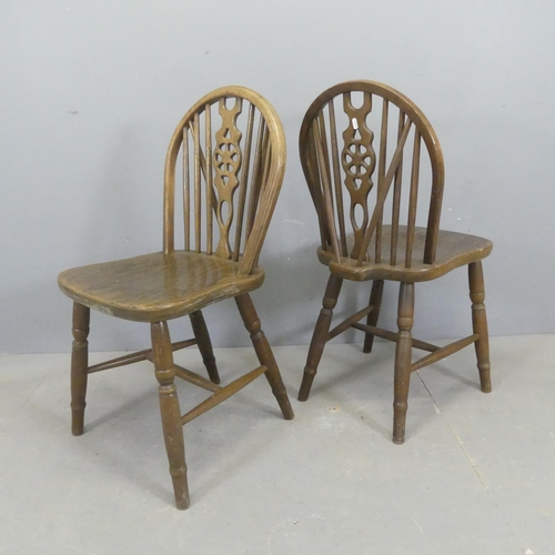 2552 - A set of four oak wheel-back dining chairs.