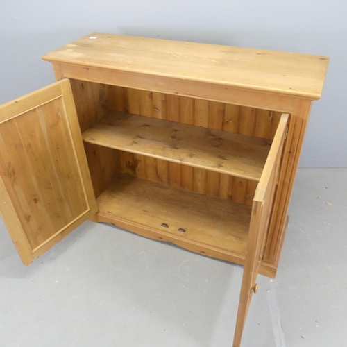 2554 - A modern pine hall cabinet, with two panelled doors and shelf fitted interior. W126cm, H109cm, D44cm... 