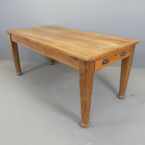 2560 - A 1930s oak dining table, with end frieze drawer and raised on tapered legs. Length 175cm, height 76... 