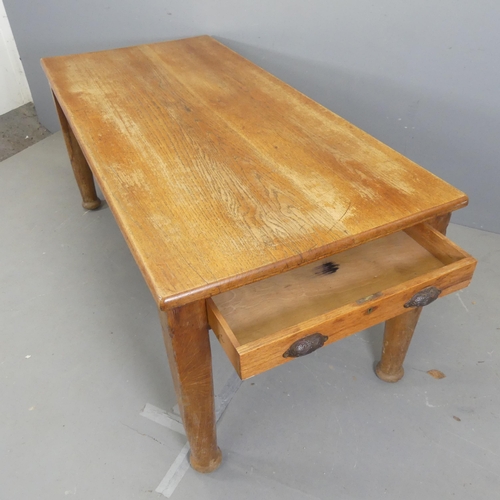 2560 - A 1930s oak dining table, with end frieze drawer and raised on tapered legs. Length 175cm, height 76... 