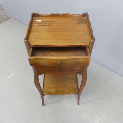 2563 - A French mahogany bedside chest of three drawers, with shelf under and raised on cabriole legs. Widt... 